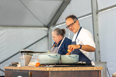 Chefs preparing tomatoes for an audience