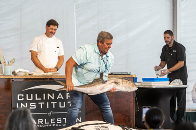 Gather staff holding a large fish